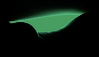 a woman's hand with a green glow in the dark
